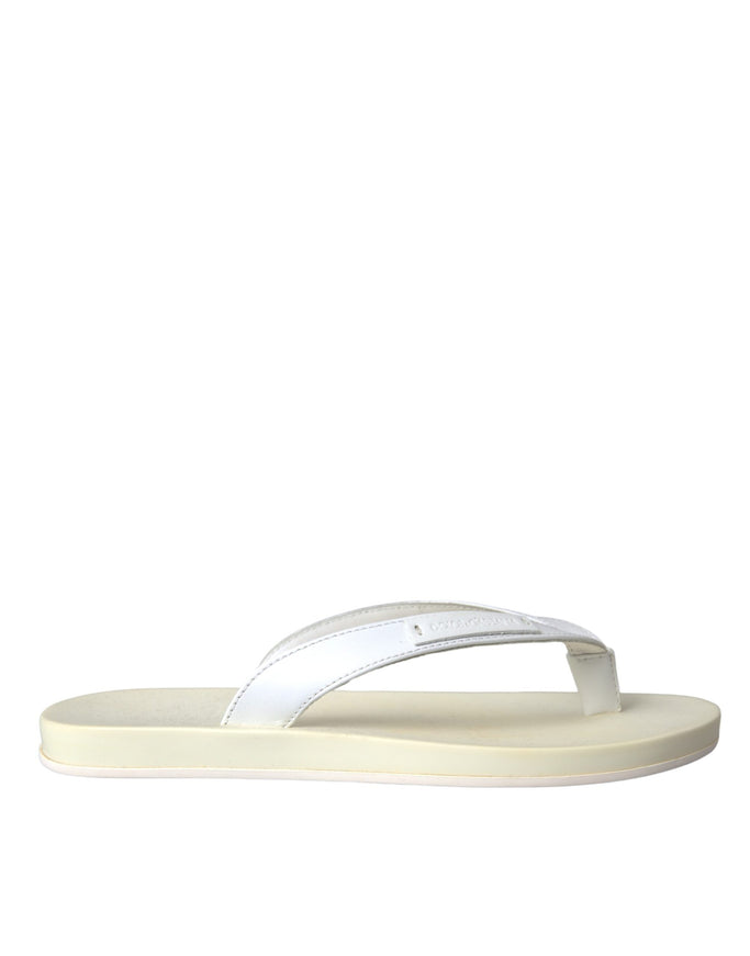 a pair of white sandals on a white background