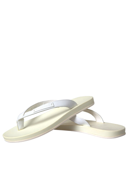 a pair of white sandals on a white background