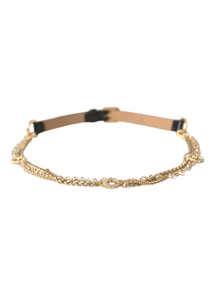 a gold chain bracelet with black leather straps