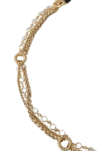 a gold chain necklace with pearls on it