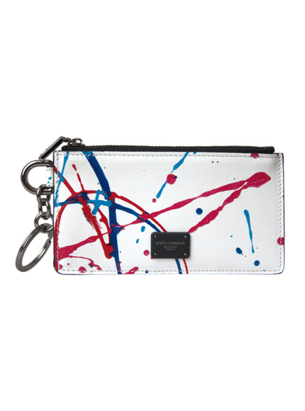 a white purse with red, blue and black paint splattered on it