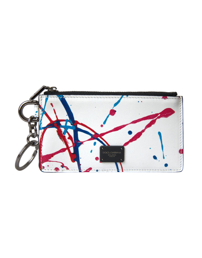 a white purse with red, blue and black paint splattered on it