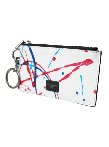 a white purse with red and blue paint splattered on it