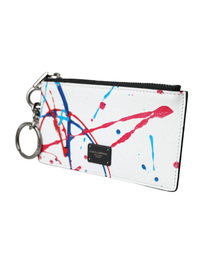 a white purse with red and blue paint splattered on it