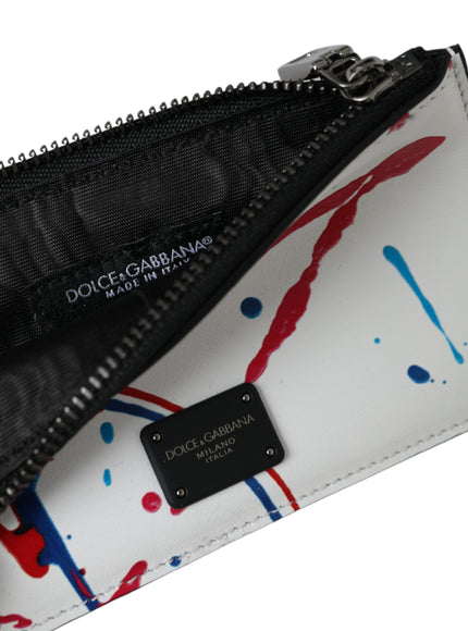 a white purse with red, blue, and black paint splattered on it