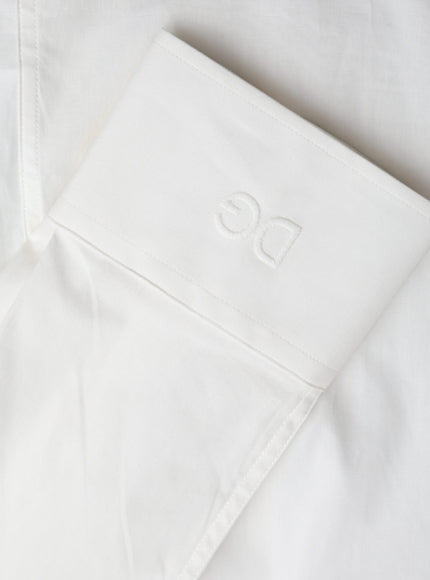 a close up of a white shirt with a logo on it