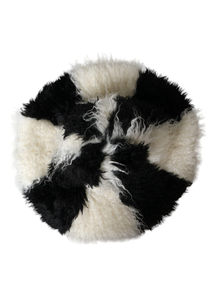 a black and white fur ball on a white background