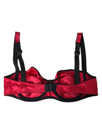 a red bra with black straps on a white background