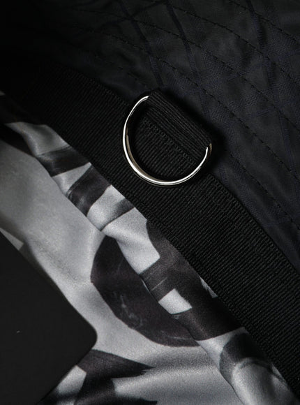 a close up of a black and white bag with a ring on it