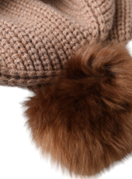 a close up of a hat with a fur ball on it