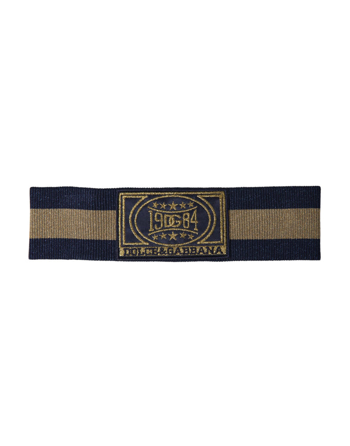 a black and gold striped belt with a logo on it