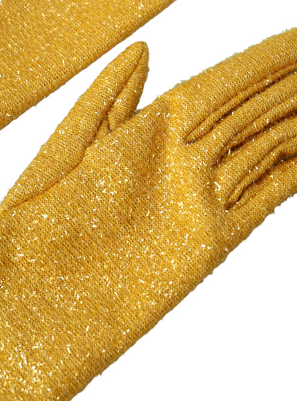 a pair of yellow glittered gloves laying on top of each other