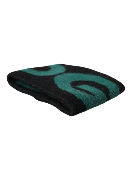 a green and black towel on a white background