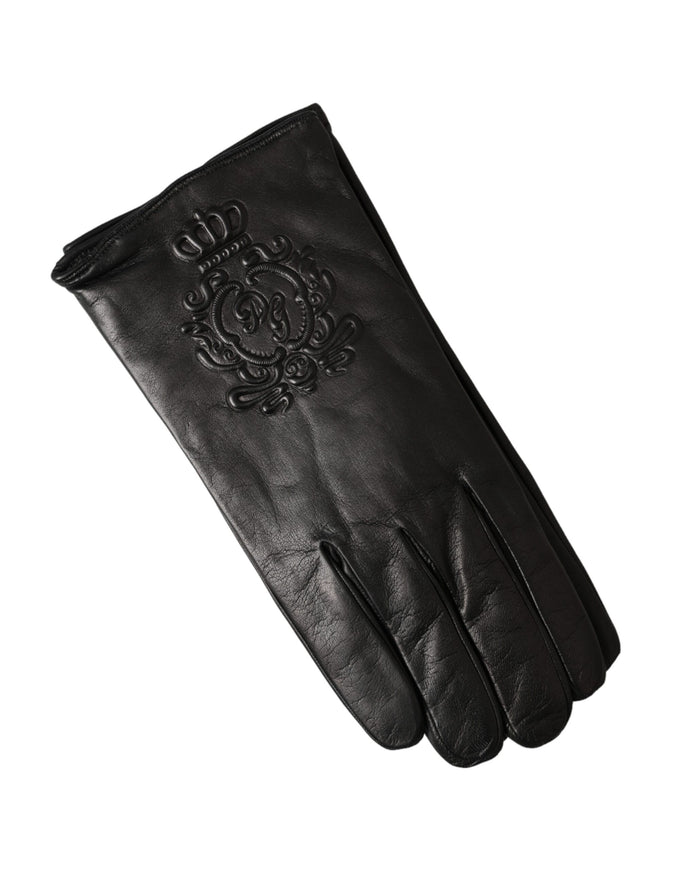 a pair of black leather gloves on a white background