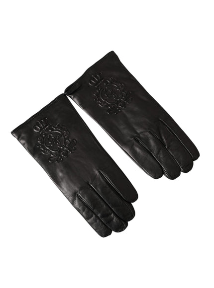 a pair of black leather gloves on a white background