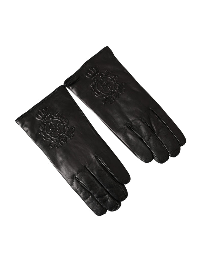 a pair of black leather gloves on a white background