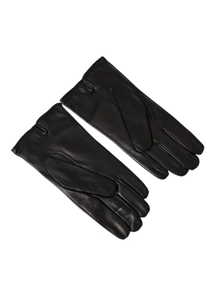 a pair of black leather gloves on a white background