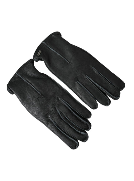 a pair of black leather gloves on a white background