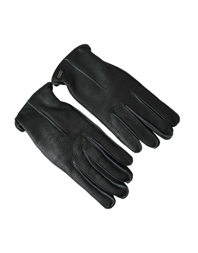 a pair of black leather gloves on a white background