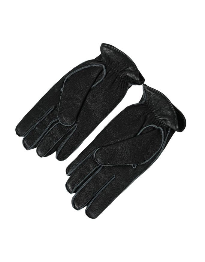 a pair of black leather gloves on a white background