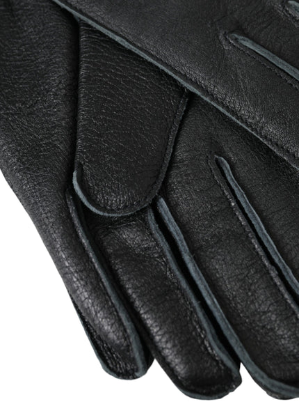 a pair of black leather gloves on a white background