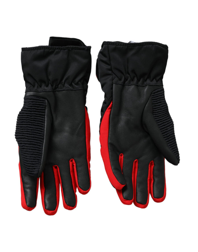 a pair of black and red gloves on a white background