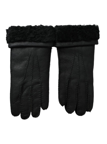 a pair of black leather gloves on a white background