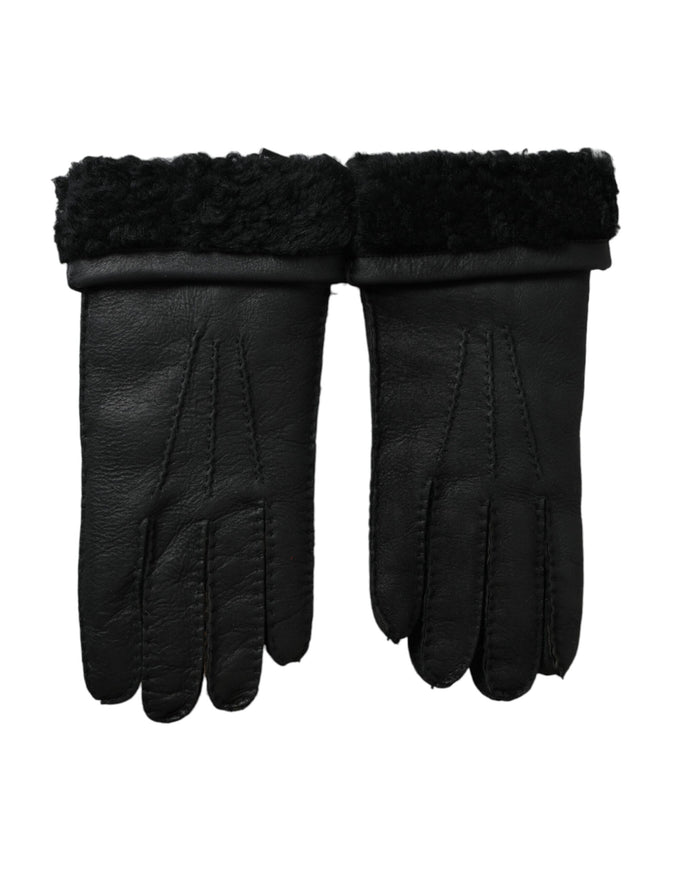 a pair of black leather gloves on a white background