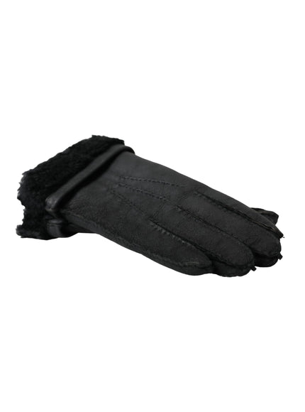 a pair of black sheepskin gloves on a white background