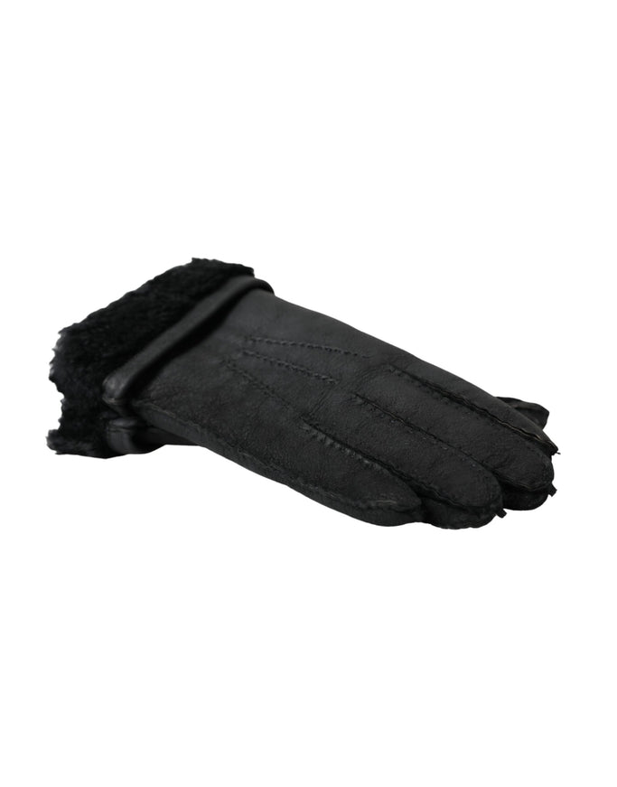 a pair of black sheepskin gloves on a white background