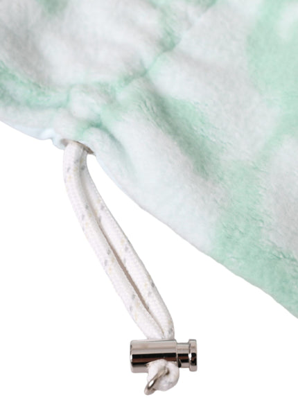 a close up of a white and green blanket