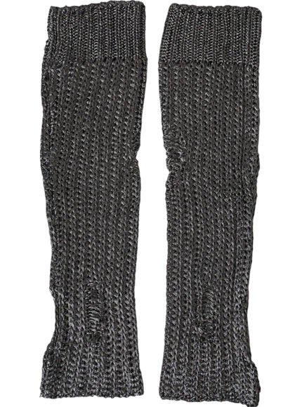 a pair of black knitted gloves on a white background