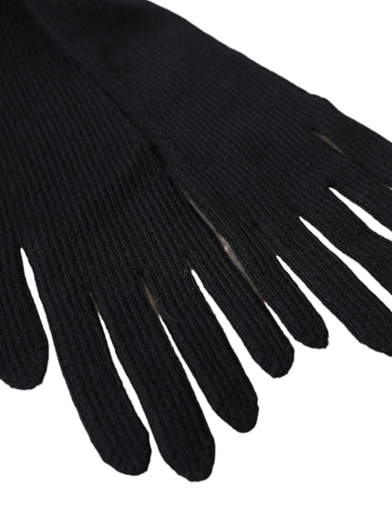 a pair of black gloves on a white background