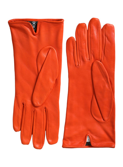 a pair of orange leather gloves on a white background