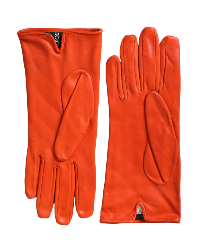 a pair of orange leather gloves on a white background