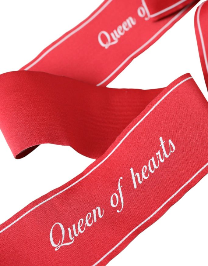 Close-up of red Queen of Hearts text on belt