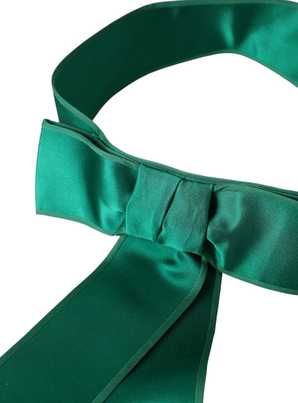 Close-up of green silk satin belt with bow detail