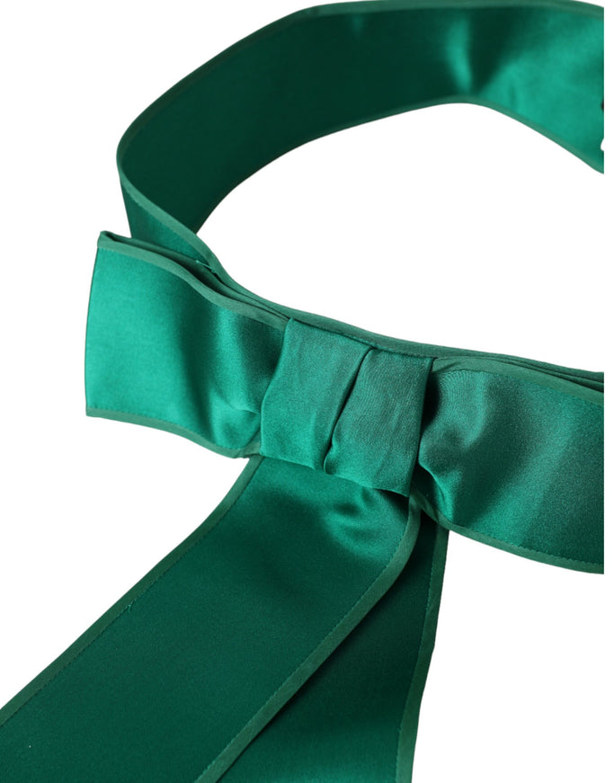 Close-up of green silk satin belt with bow detail