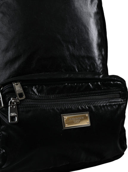 a black backpack with a gold buckle on it