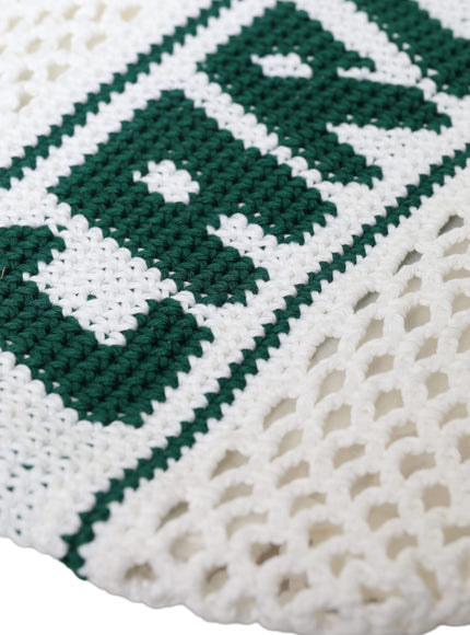 a close up of a knitted object on a white surface