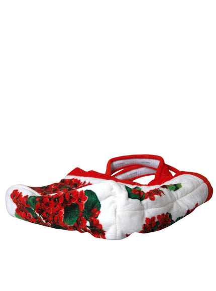 a pair of slippers with red flowers on them