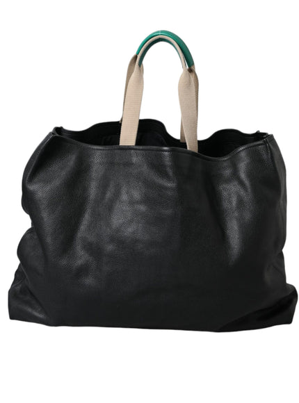 a black leather bag with a green handle