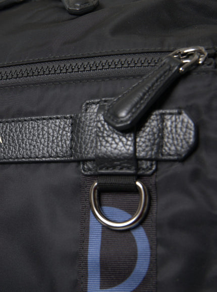 a close up of a black bag with a blue logo on it