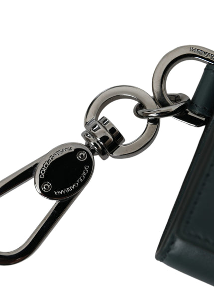 a close up of a key chain with a wallet in the background