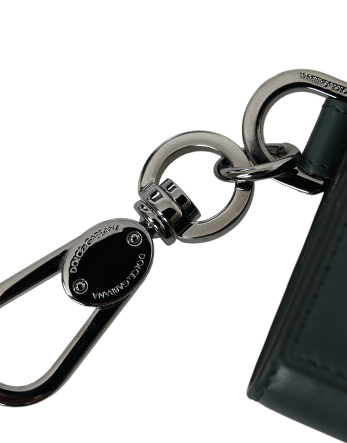 a close up of a key chain with a wallet in the background