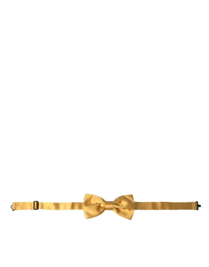 a gold bow tie on a white background