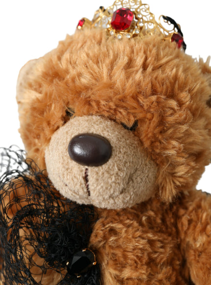 Close-up of teddy bear with gold crystal crown on hair band