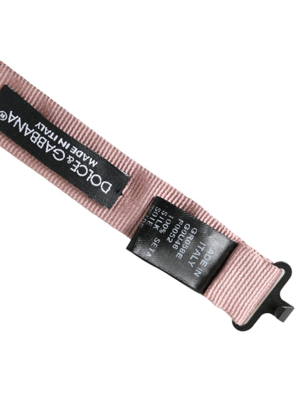 a pink belt with a black tag on it