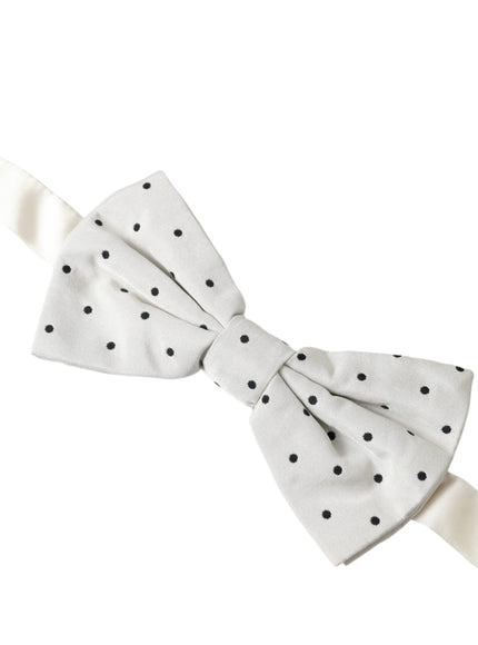 a white bow with black polka dots on it