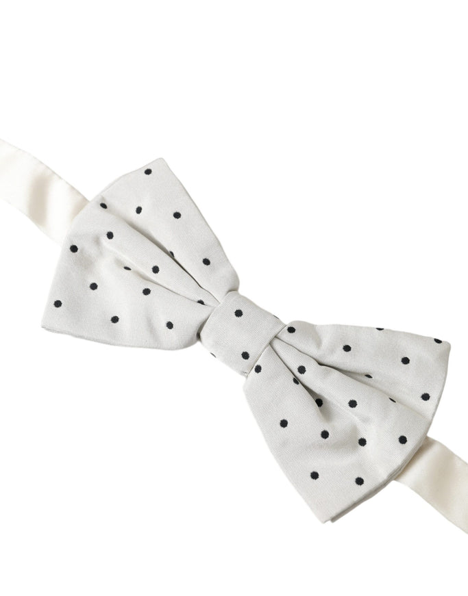 a white bow with black polka dots on it